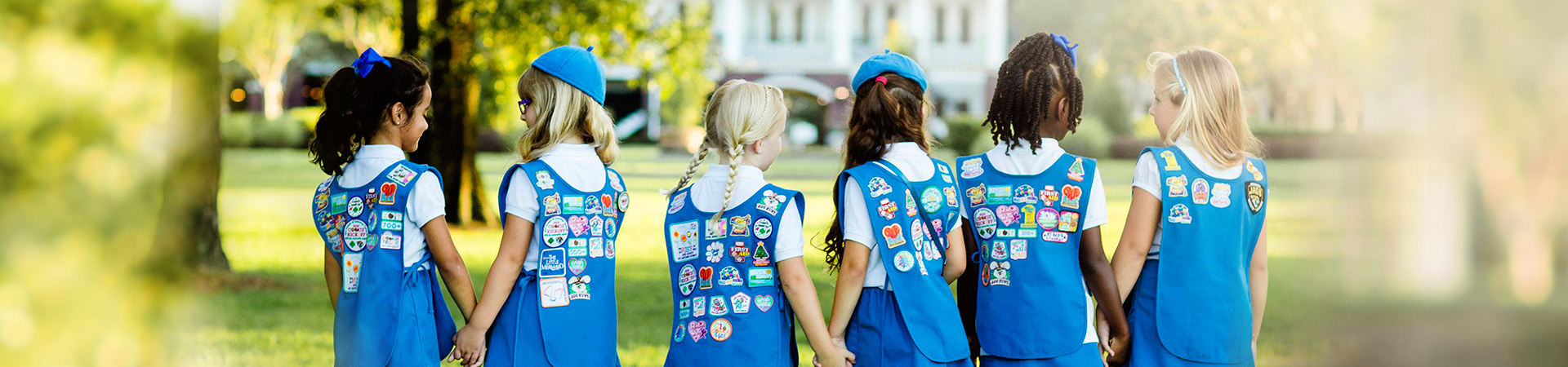 Group of Junior Girl Scouts smiling and laughing outdoors 